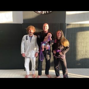 Black Submit everyone gi with pink letters.